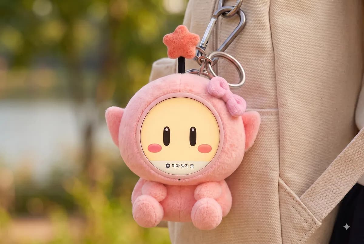 Kkumsoon keyring clipped to a backpack